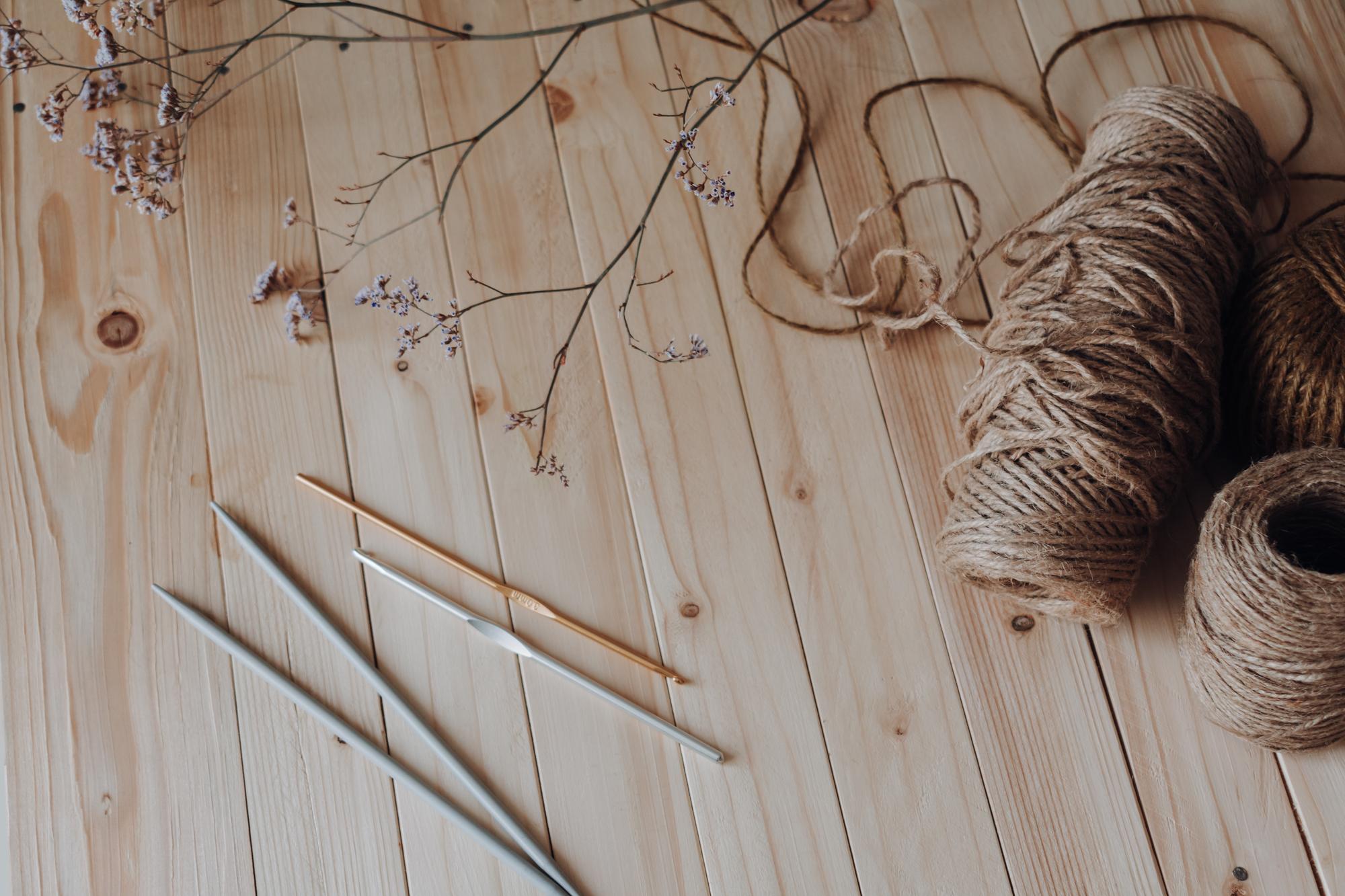 studio workspace with threads, needles and sketches