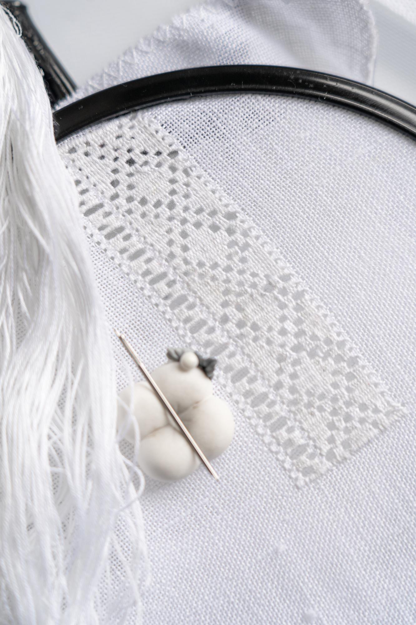 detailing of elegant hand embroidery on linen